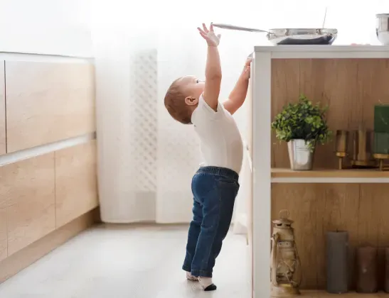 toddler-reaching-for-metal-pan-handle[1]